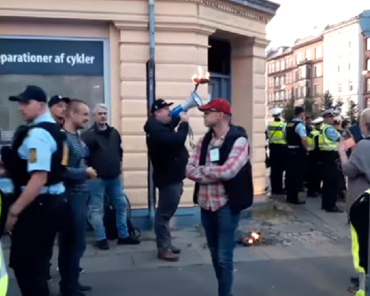 Burning of Quran under police protection in Norrebro, Copenhagen, Denmark in 2019. 