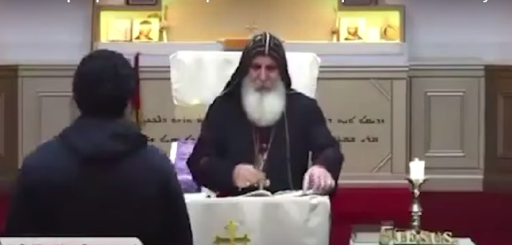 Suspect approaches Bishop Mar Mari Emmanuel at livestreamed service in Wakeley, Australia.