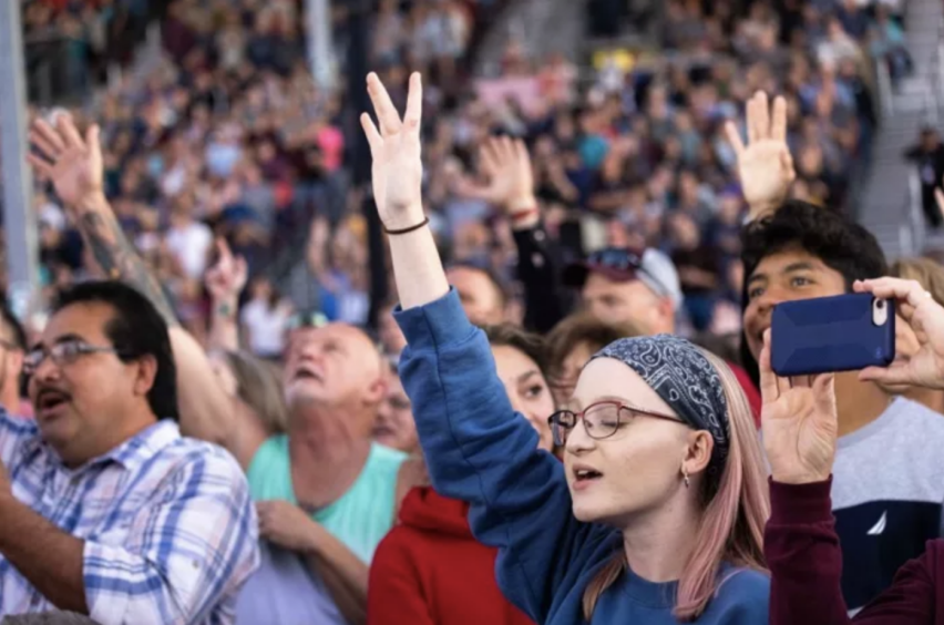 Attendees raise their hands in worship during Franklin Graham's Route 66