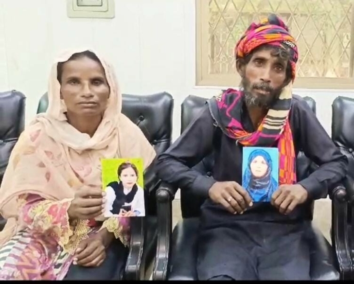 Sumera Bibi and her husband with portraits of their forcibly converted and married daughters who were kidnapped in Kasur District, Pakistan on July 23, 2024. 