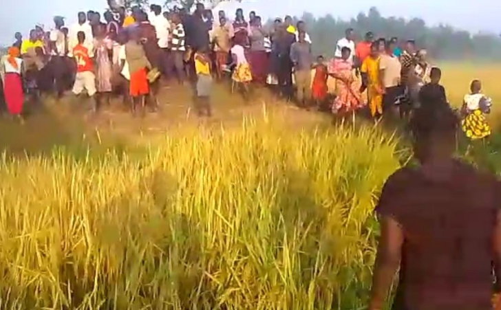Villagers gather where the body of James Mukenye Habiibu was found on Dec. 17, 2024 in Kibuku District, Uganda.