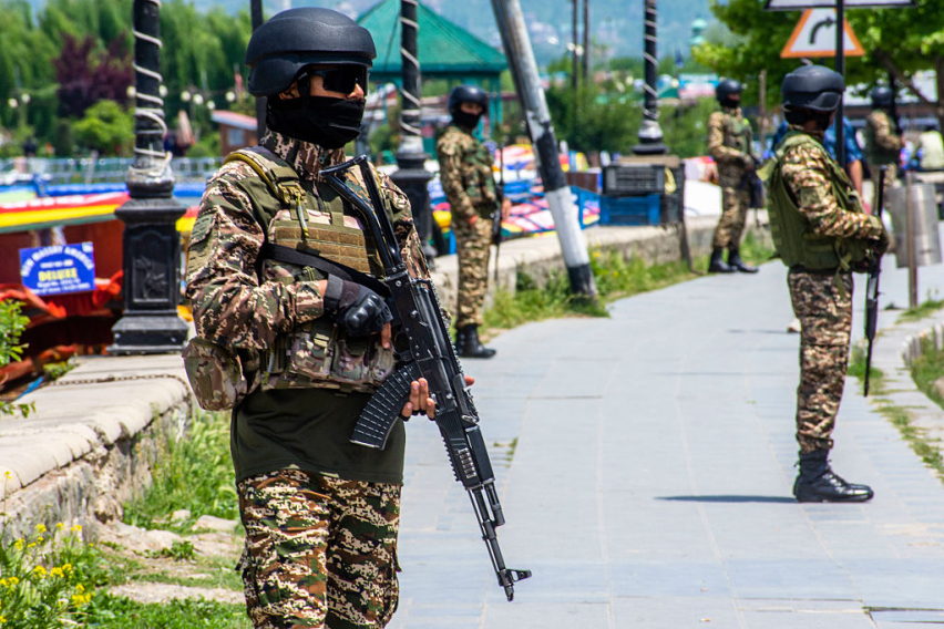 Indian paramilitary soldiers stand guard on the bank of Dal lake