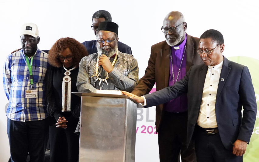 Rev. Dr. Jean Libom Li Likeng, newly elected president of the Association of Evangelicals in Africa (AEA), leads a prayer of commissioning for the second edition of the Africa Bible Commentary during the 13th AEA General Assembly in Nairobi, Kenya