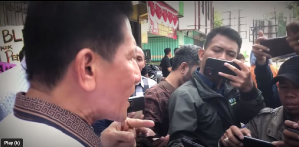 Pastor Herri Soesanto objects to manhandling at sealing of church in Jombang, East Java Province, Indonesia.