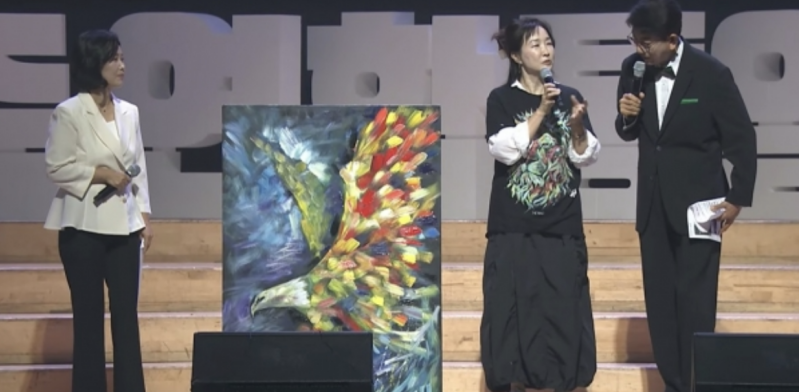 Artist Janet Hyun explains her painting of an eagle carrying a key, symbolizing the recovery of God’s mission for reunification and the call to soar with purpose.