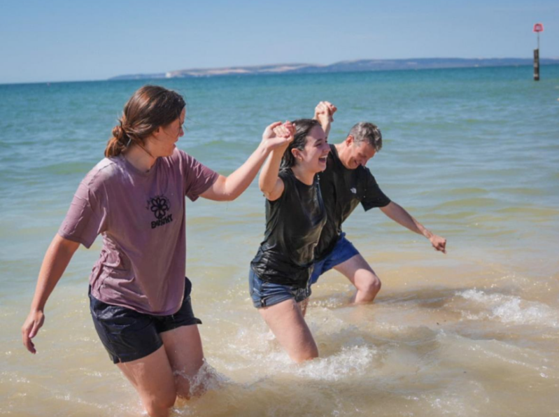 92 people get baptised together in the sea off the coast of England