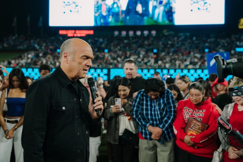 Pastor Greg Laurie prays over thousands who came forward to make a profession of faith during the Harvest Crusade at Angel Stadium in Anaheim, California.
