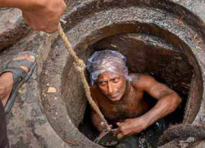 A sanitation worker in Pakistan performs duties without protective gear, highlighting the unsafe and hazardous conditions many face daily despite legal labor protections.