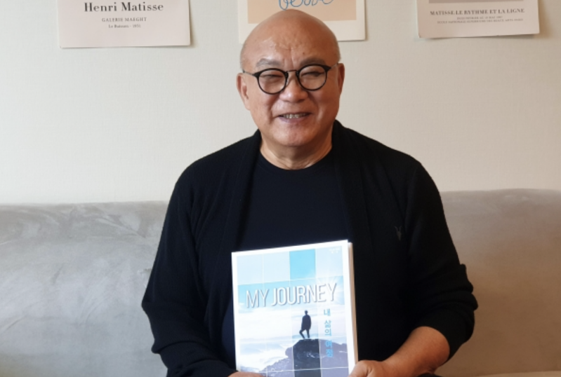Rev. Lee Byung-il holds My Journey, a small-group discipleship resource for men’s ministry.
