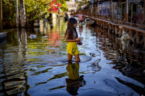 A resident wades through floodwater in Dela Paz village, Laguna province, after Tropical Storm Trami in 2024. Lawmakers and church leaders warn that corruption and defective flood control projects have worsened the impact of disasters in one of the world’