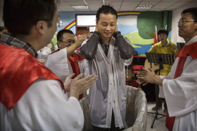 A Chinese Christian man stands after being baptized by a pastor during a ceremony at an underground independent Protestant church on October 12, 2014 in Beijing, China. According to the widest definition used by researchers, China is home to the largest e