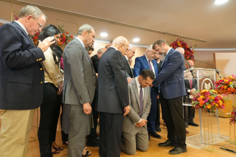 Members of the Arab Baptist Theological Seminary leadership team lay hands in prayer over incoming President Wissam Nasrallah during the Passing the Baton ceremony in Beirut, Lebanon, on Sept. 28, 2025.