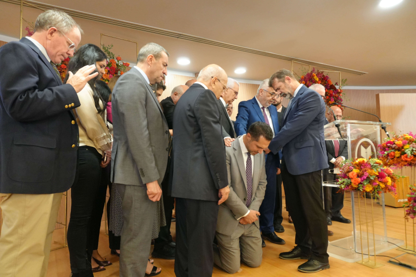 Members of the Arab Baptist Theological Seminary leadership team lay hands in prayer over incoming President Wissam Nasrallah during the Passing the Baton ceremony in Beirut, Lebanon, on Sept. 28, 2025.