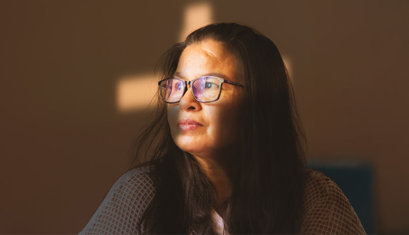 Asian Woman Illuminated with a Cross