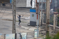 A man throws an object as youth-led protests over longstanding water and power cuts continue on September 30, 2025 in Antananarivo, Madagascar.
