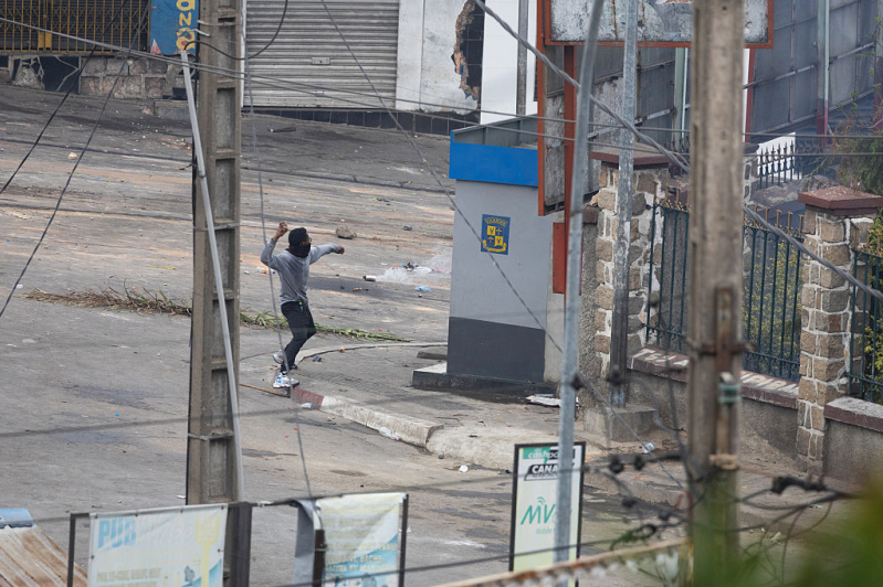 A man throws an object as youth-led protests over longstanding water and power cuts continue on September 30, 2025 in Antananarivo, Madagascar.