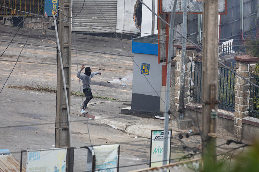 A man throws an object as youth-led protests over longstanding water and power cuts continue on September 30, 2025 in Antananarivo, Madagascar.