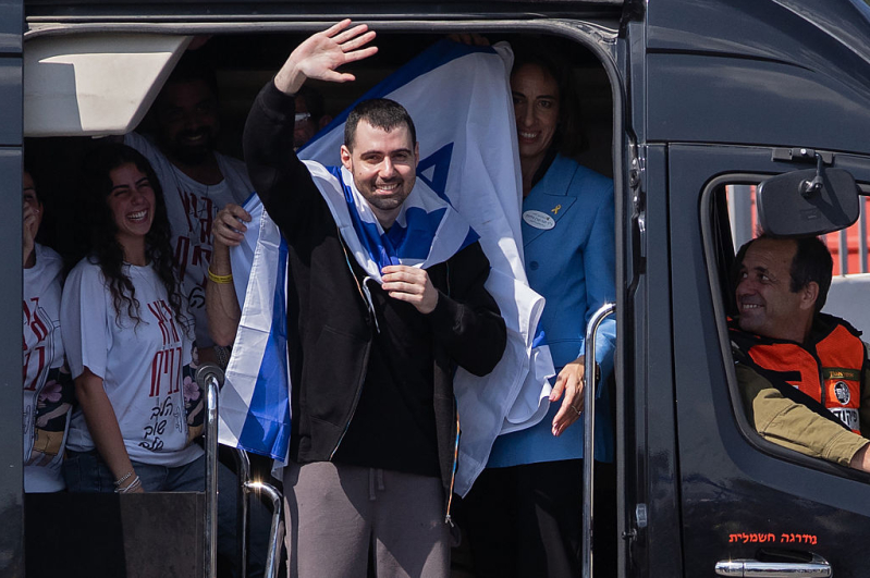 Former hostage Guy Gilboa-Dalal waves to supporters outside Beilinson Hospital in the Rabin Medical Centre on October 13, 2025 in Petah Tikva, Israel.