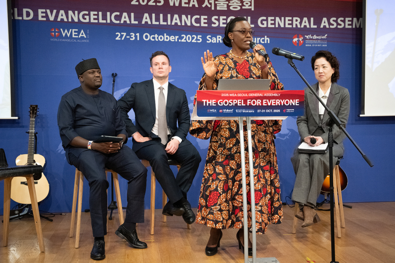 Dr. Wanjiru M. Gitau speaks during the “Living the Gospel in Global Growth” panel at the World Evangelical Alliance General Assembly in Seoul, joined by Dr. David Tarus (first left), Jayson Mandryk (second left), and moderator Dr. Lisa Pak (right).