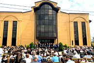 Worship meeting outside closed Kurganinsk Council of Churches Baptist church in August 2025.