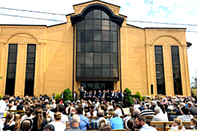Worship meeting outside closed Kurganinsk Council of Churches Baptist church in August 2025.