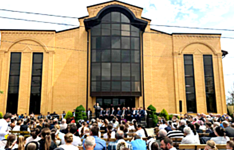 Worship meeting outside closed Kurganinsk Council of Churches Baptist church in August 2025.