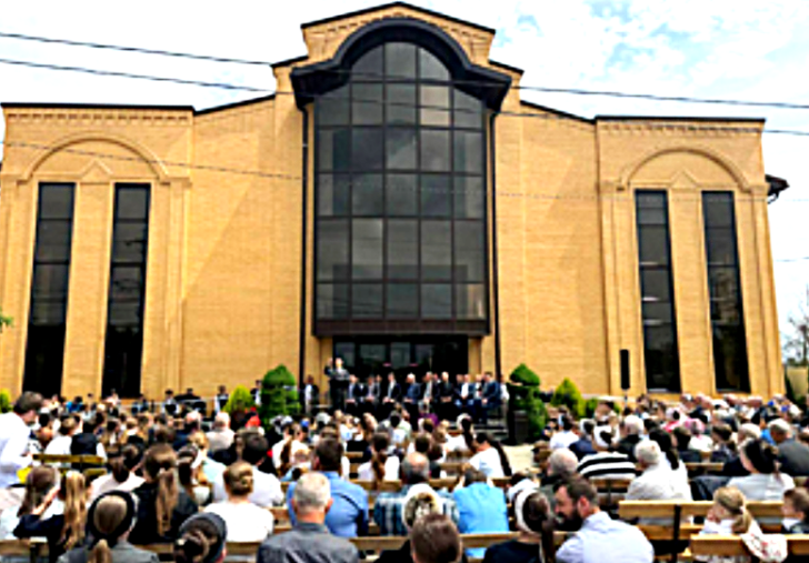 Worship meeting outside closed Kurganinsk Council of Churches Baptist church in August 2025.