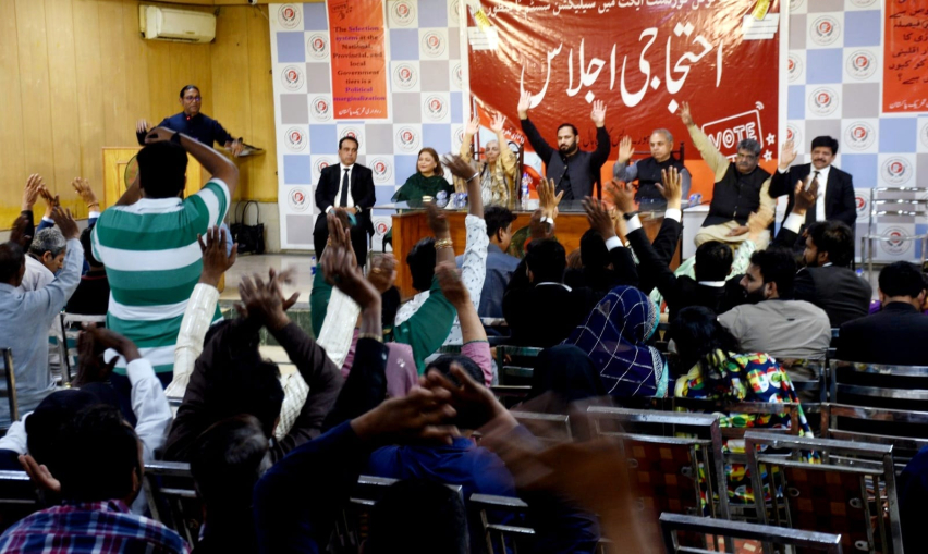 Participants of a peoples assembly protest against the new Local Government Act that bars direct election on reserved seats for minorities