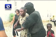 Security personnel escort one of 38 released Christians following their Nov. 21, 2025 kidnapping in Eruku village, Kwara state, Nigeria.