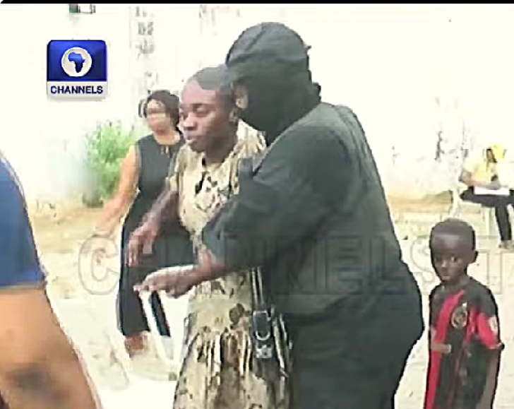 Security personnel escort one of 38 released Christians following their Nov. 21, 2025 kidnapping in Eruku village, Kwara state, Nigeria.