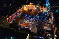 An aerial view of Bethlehem’s Manger Square shows large crowds gathered around the illuminated Christmas tree during the city’s first public celebration in two years.
