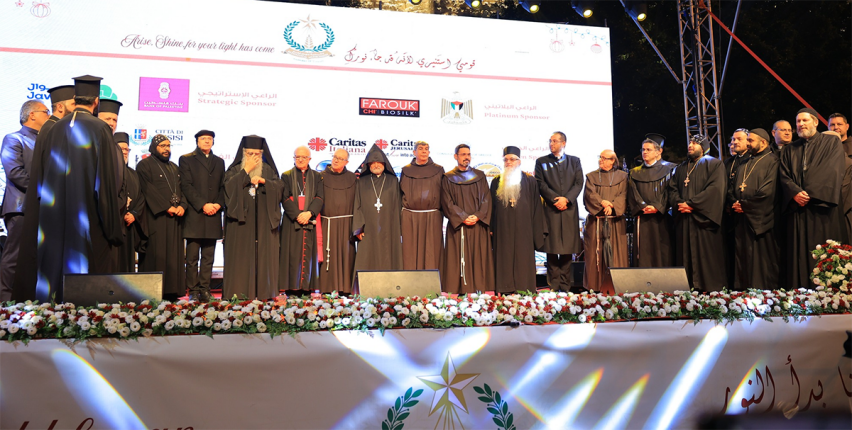 Leaders from various Christian traditions stand together on stage during the Bethlehem Christmas tree lighting, offering prayers and messages of unity and hope.