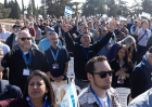 Members of a US delegation pray and wave Israeli flags as they gather at Mount Herzl to meet with families of soldiers killed during the Oct 7 war on December 3, 2025 in Jerusalem, Israel.