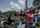 A father and child on a hillside where mourners attend the July 11, 2025, funeral of Boniface Kariuki in Iyego village, Murang’a County, Kenya