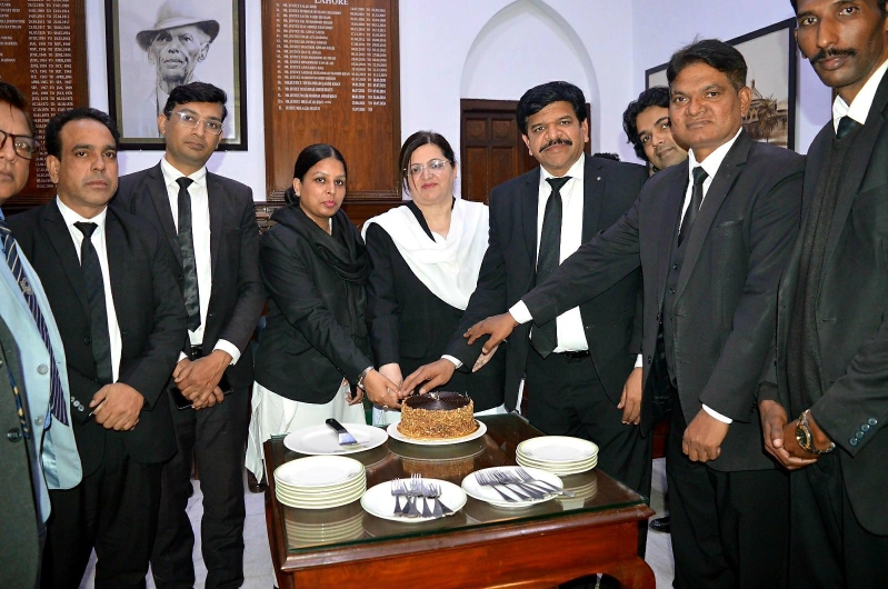 Lahore High Court Chief Justice Aalia Neelum cuts a cake with Christian lawyers during a Christmas observance at the Lahore High Court on Dec. 14, 2025.