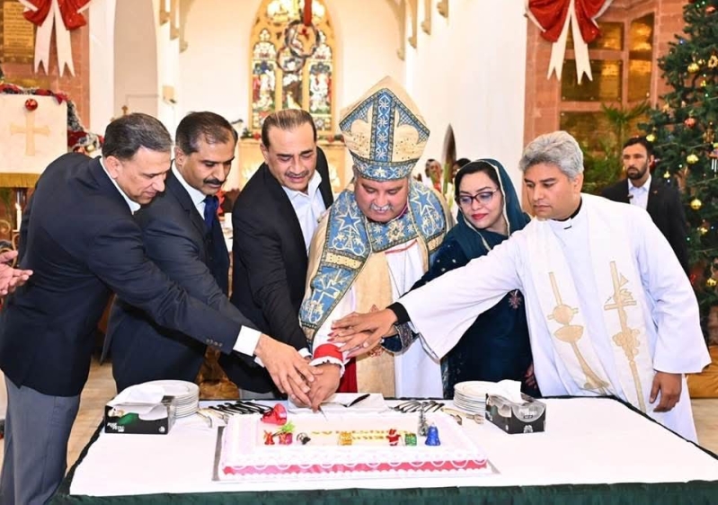 Pakistans Chief of Defense Forces Field Marshal Asim Munir cuts a Christmas cake with Church of Pakistans Bishop of Lahore Diocese Nadeem Kamran during the special mass on Dec. 25, 2025.