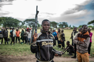A Wazalendo militant surrenders a weapon to members of the Rwanda-backed M23 rebel group in Uvira, eastern Democratic Republic of Congo, days after the rebels captured the South Kivu city.