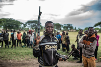 A Wazalendo militant surrenders a weapon to members of the Rwanda-backed M23 rebel group in Uvira, eastern Democratic Republic of Congo, days after the rebels captured the South Kivu city.