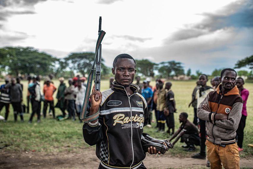 A Wazalendo militant surrenders a weapon to members of the Rwanda-backed M23 rebel group in Uvira, eastern Democratic Republic of Congo, days after the rebels captured the South Kivu city.