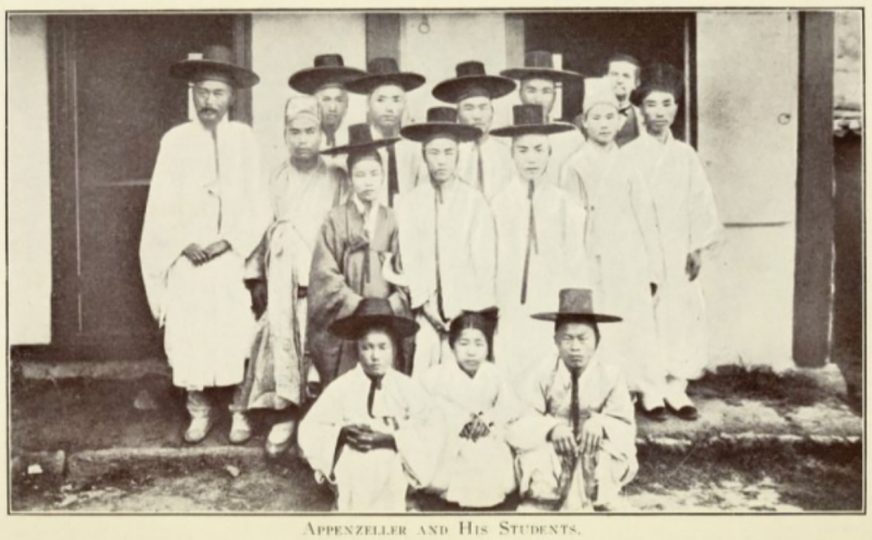 Missionary Henry G. Appenzeller is pictured with students of Pai Chai Academy, which he founded, in an 1887 photograph. Appenzeller stands at the far right of the back row, his face partially obscured.