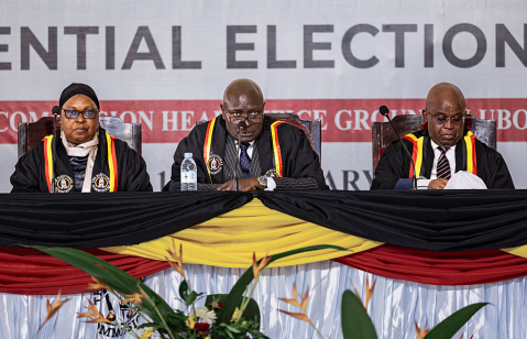 The Ugandan Electoral Commission Chairman, Justice Byabakama Mugenyi Simon (C) among with other Electoral Commission officials anounces the result of the 2026 elections at the Tally Centre on January 16, 2026 in Lubowa, Uganda.