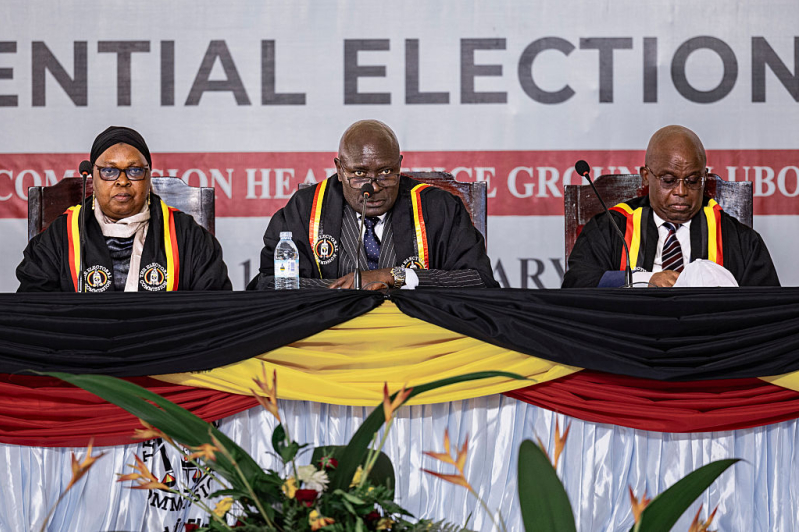 The Ugandan Electoral Commission Chairman, Justice Byabakama Mugenyi Simon (C) among with other Electoral Commission officials anounces the result of the 2026 elections at the Tally Centre on January 16, 2026 in Lubowa, Uganda.