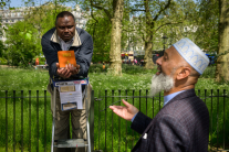 A Christian and a Muslim engage in a public debate at Speaker’s Corner in Hyde Park in London, UK, where open discussions on religion and belief have long been a feature of public life.