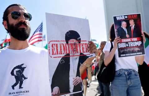 LOS ANGELES - FEBRUARY 28: A man holds a picture of Iranian leader Ayatollah Ali Khamenei reading ELIMINATED as members of the Iranian community and supporters celebrate on February 28, 2026 in Los Angeles, California.