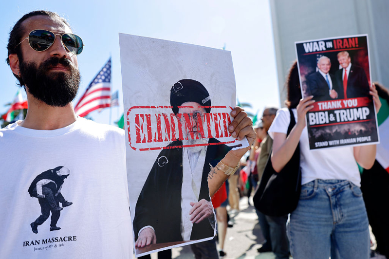 LOS ANGELES - FEBRUARY 28: A man holds a picture of Iranian leader Ayatollah Ali Khamenei reading ELIMINATED as members of the Iranian community and supporters celebrate on February 28, 2026 in Los Angeles, California.