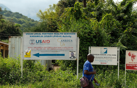 A man walks past a USAID road signage in Moroto town, on July 22, 2025 in Moroto, Uganda.