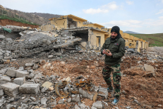 A fighter shows piece of Iranian missile