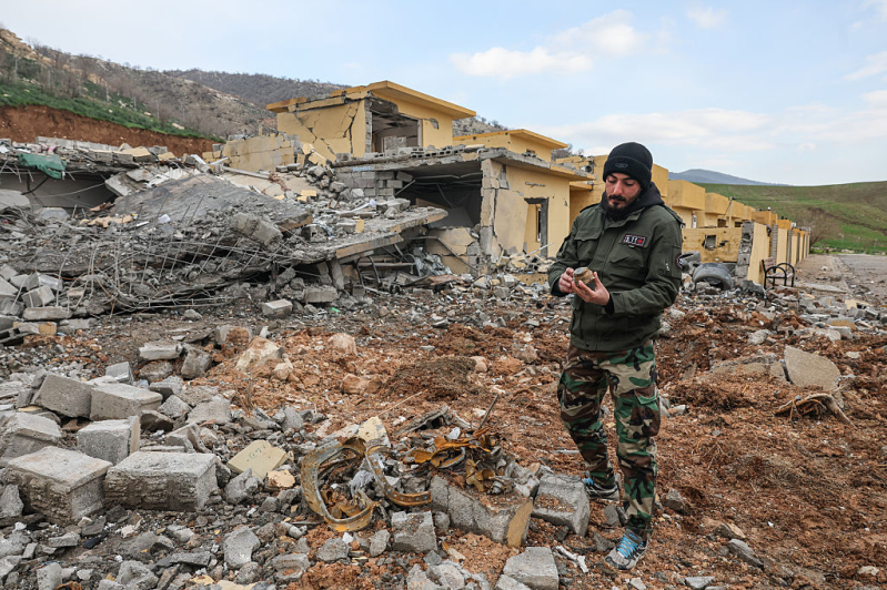 A fighter shows piece of Iranian missile