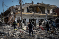 Firefighters search a building for survivors shortly after an Israeli airstrike on April 13, 2026 in Nabatieh, Lebanon.