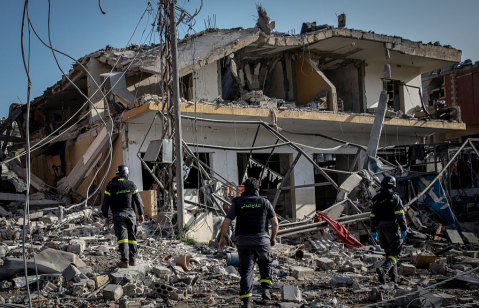 Firefighters search a building for survivors shortly after an Israeli airstrike on April 13, 2026 in Nabatieh, Lebanon.